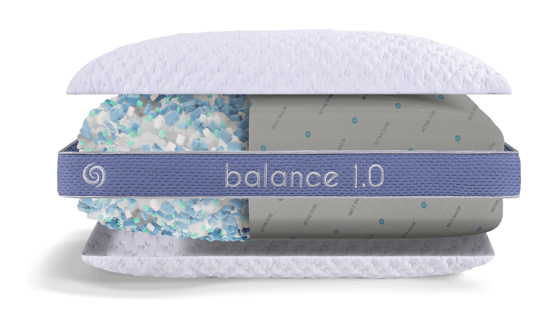 Women Sitting on a Bed Hugging Balance Pillow 3.0 with a Balance Pillow 2.0 sitting next to her